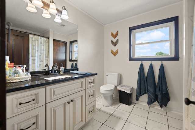 bathroom with crown molding, vanity, tile patterned flooring, and toilet