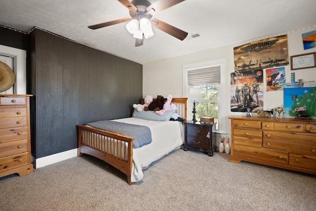 bedroom featuring ceiling fan and light carpet