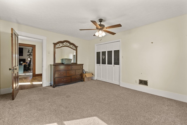 carpeted bedroom with a closet and ceiling fan