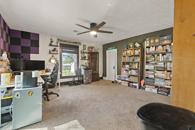 carpeted home office featuring ceiling fan and a textured ceiling