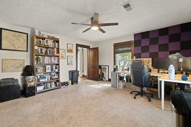 office area with ceiling fan, light colored carpet, and a textured ceiling