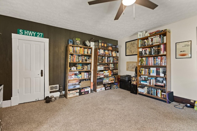 misc room with ceiling fan, a textured ceiling, and carpet flooring