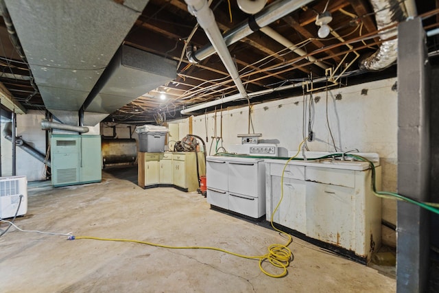 basement with heating unit and washer and clothes dryer