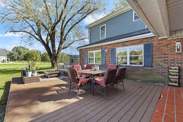 deck with an outdoor fire pit and a yard