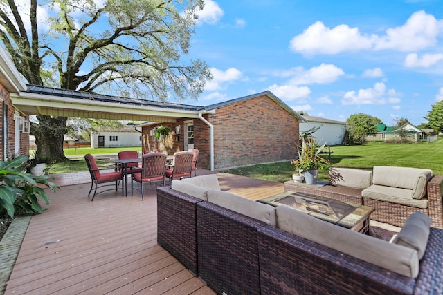 wooden terrace featuring an outdoor hangout area and a yard