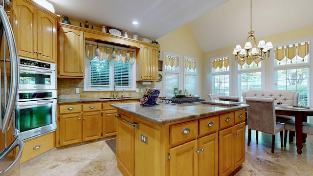 kitchen featuring lofted ceiling, decorative backsplash, an inviting chandelier, decorative light fixtures, and a center island