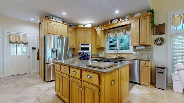 kitchen featuring decorative backsplash, stainless steel appliances, a wealth of natural light, and a kitchen island