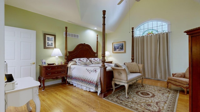 bedroom featuring light hardwood / wood-style flooring, high vaulted ceiling, and ceiling fan