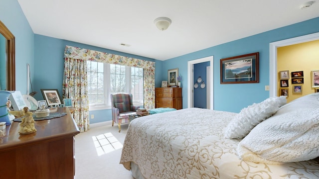 bedroom featuring light colored carpet