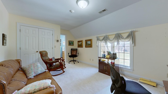 carpeted home office with lofted ceiling