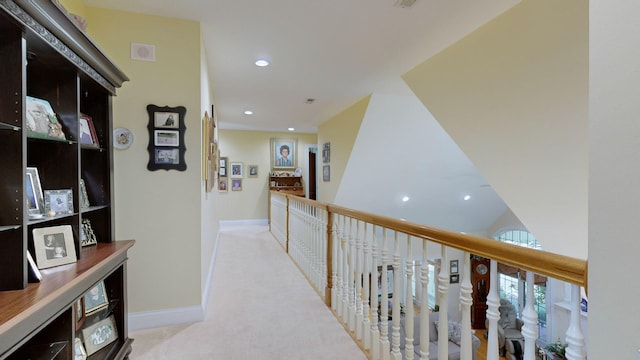 hall featuring light colored carpet