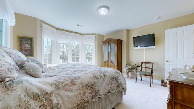 bedroom featuring light carpet