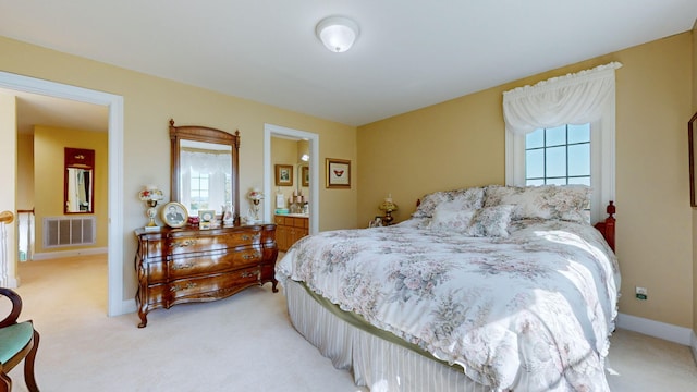 carpeted bedroom featuring ensuite bathroom