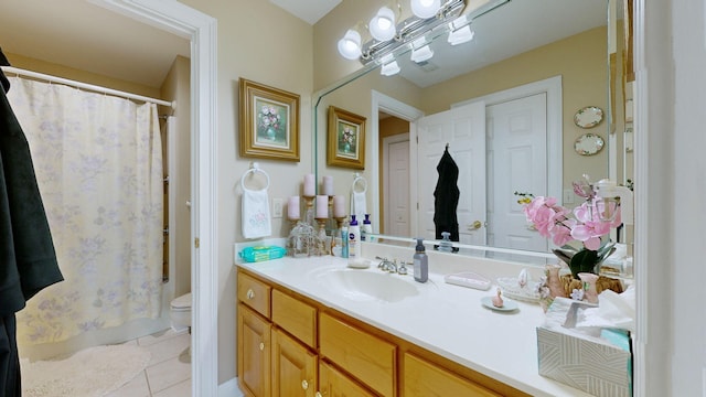 bathroom featuring vanity, toilet, and tile patterned floors