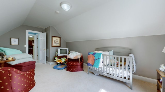 bedroom with carpet flooring, vaulted ceiling, and a crib