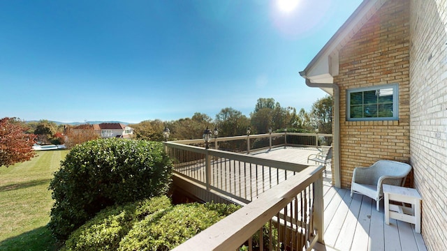 wooden terrace with a yard