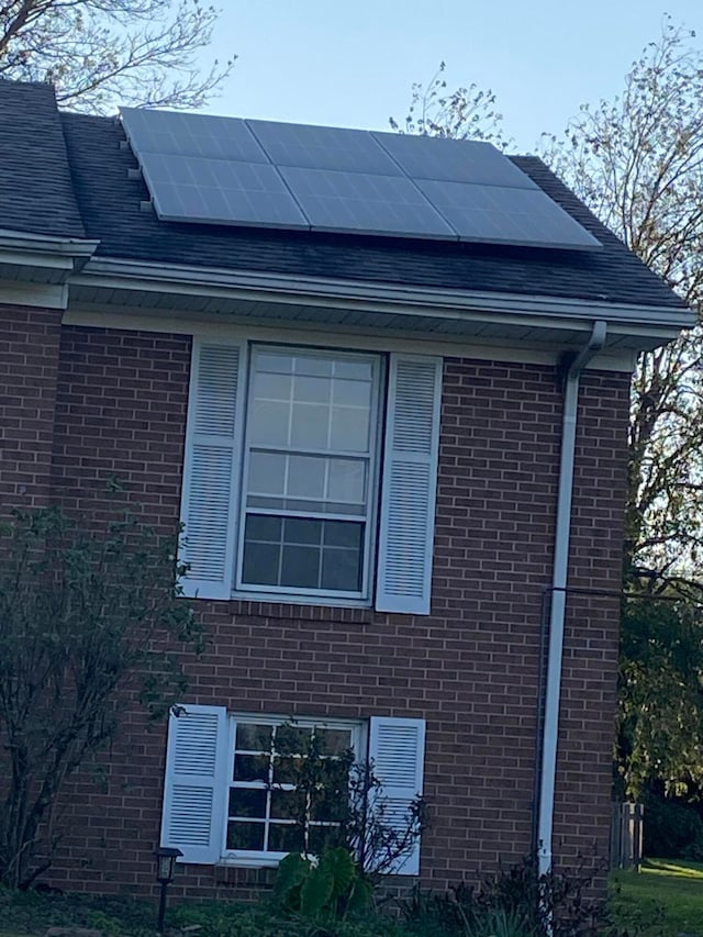 view of property exterior with solar panels