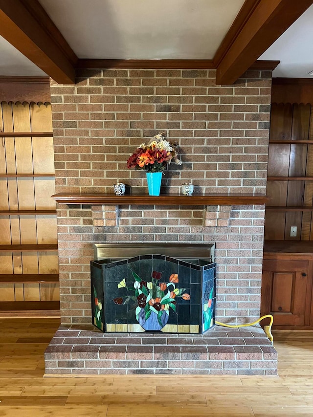 room details with a brick fireplace, crown molding, and hardwood / wood-style floors