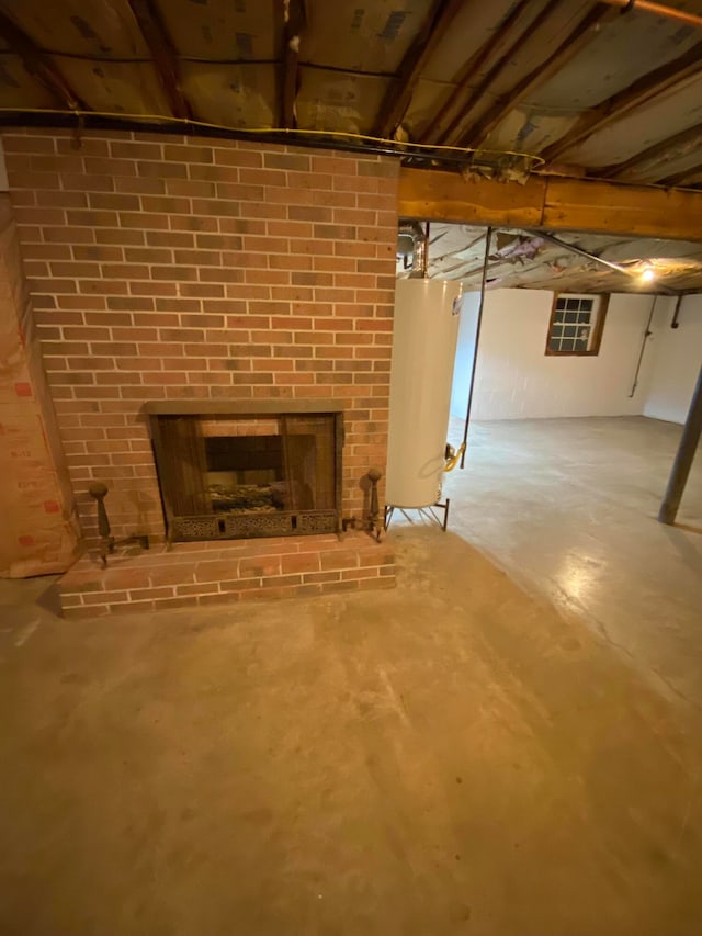 basement with water heater and a fireplace