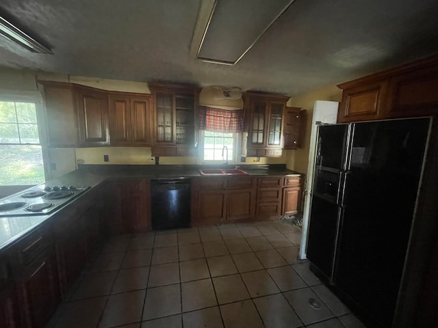 kitchen with tile patterned floors, sink, and black appliances