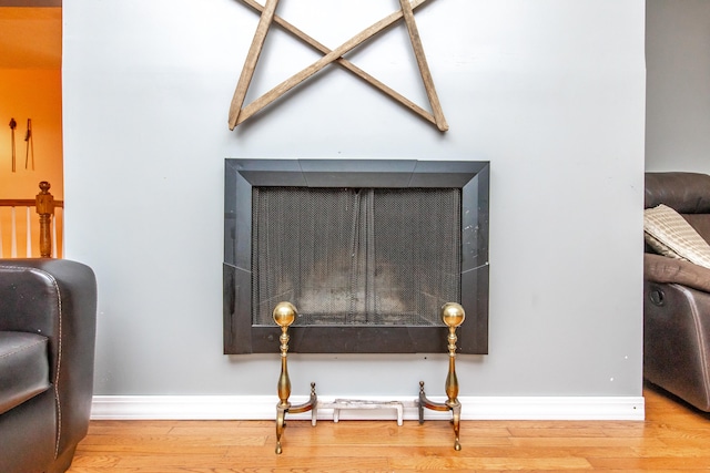 interior details with hardwood / wood-style flooring and a fireplace