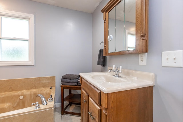 bathroom featuring vanity, a bathing tub, and tile patterned flooring