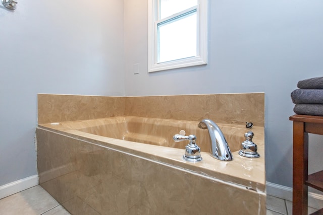 bathroom with tiled bath and tile patterned floors