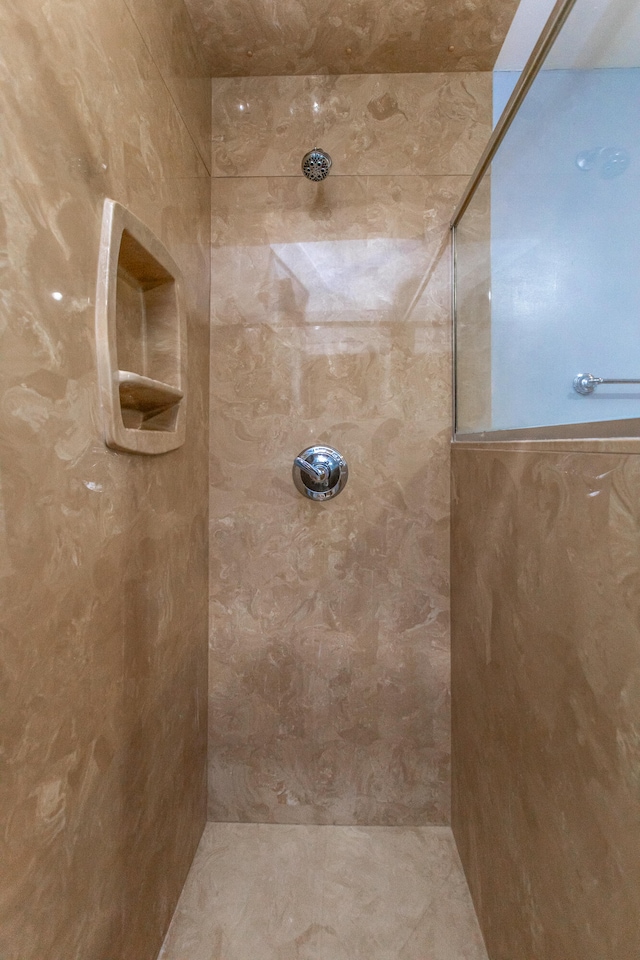 bathroom with tiled shower