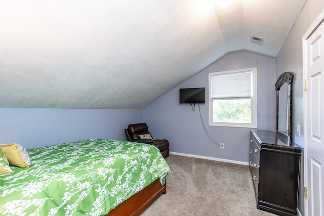 bedroom featuring lofted ceiling and light colored carpet