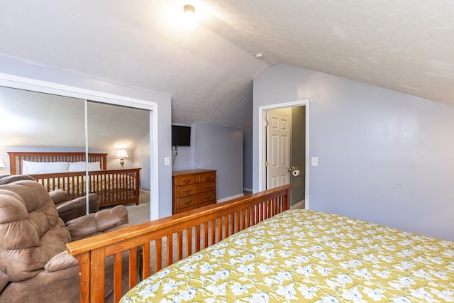 bedroom featuring vaulted ceiling and a closet