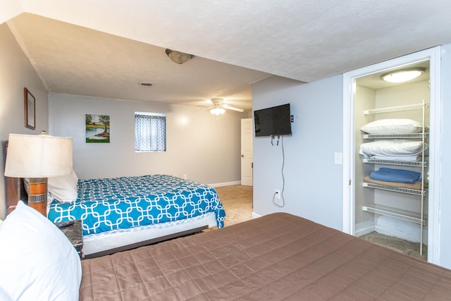 carpeted bedroom featuring a textured ceiling and ceiling fan