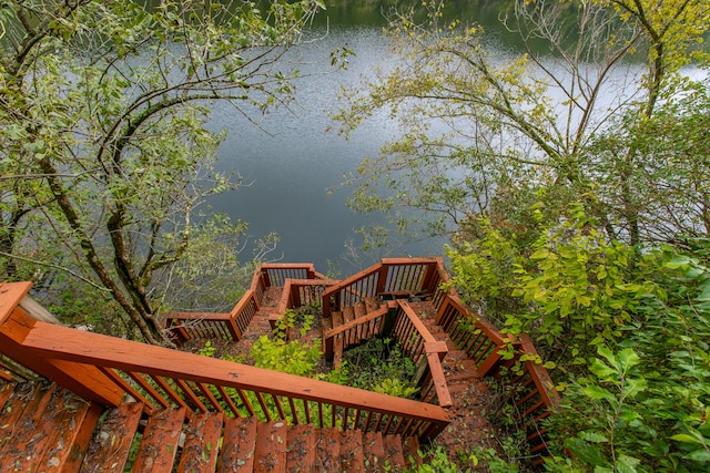 wooden terrace featuring a water view