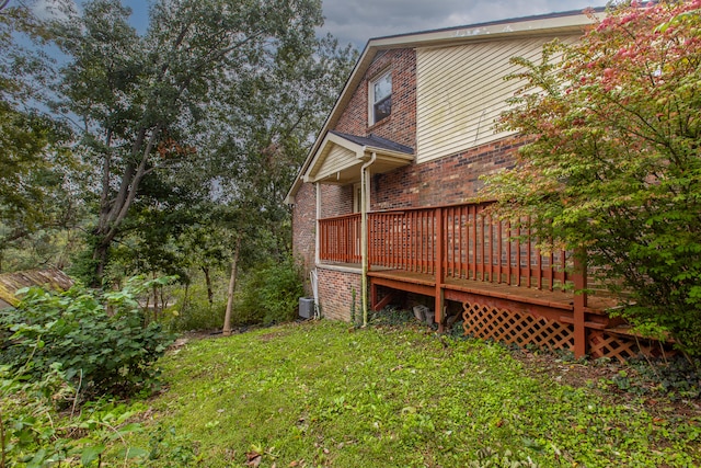 view of yard featuring a wooden deck and cooling unit