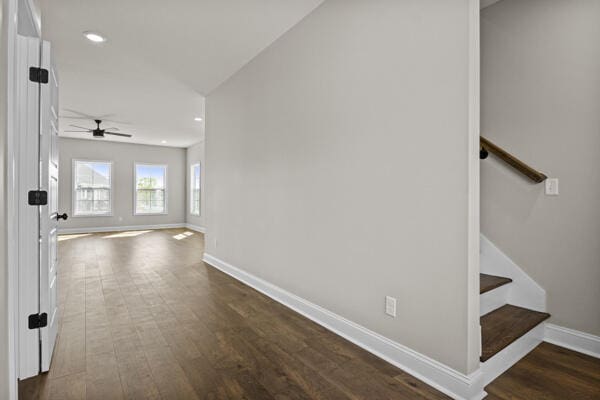 hallway featuring baseboards, recessed lighting, stairway, and dark wood finished floors