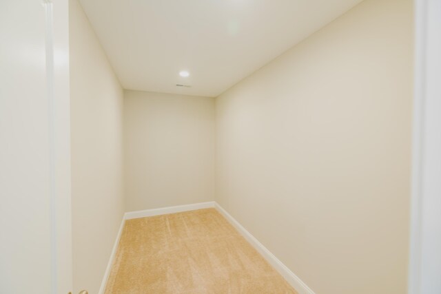 bathroom featuring hardwood / wood-style floors and a relaxing tiled tub