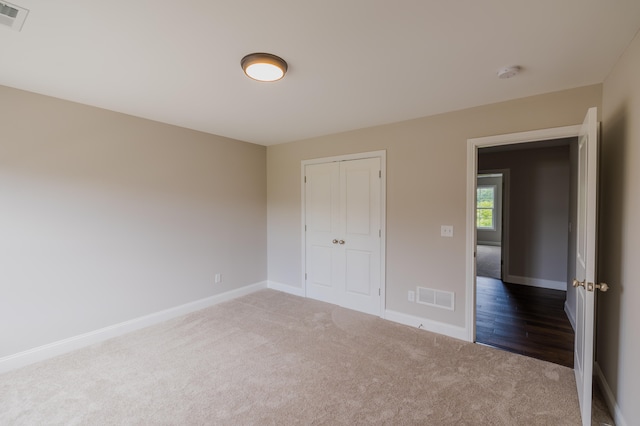 unfurnished bedroom featuring a closet and carpet