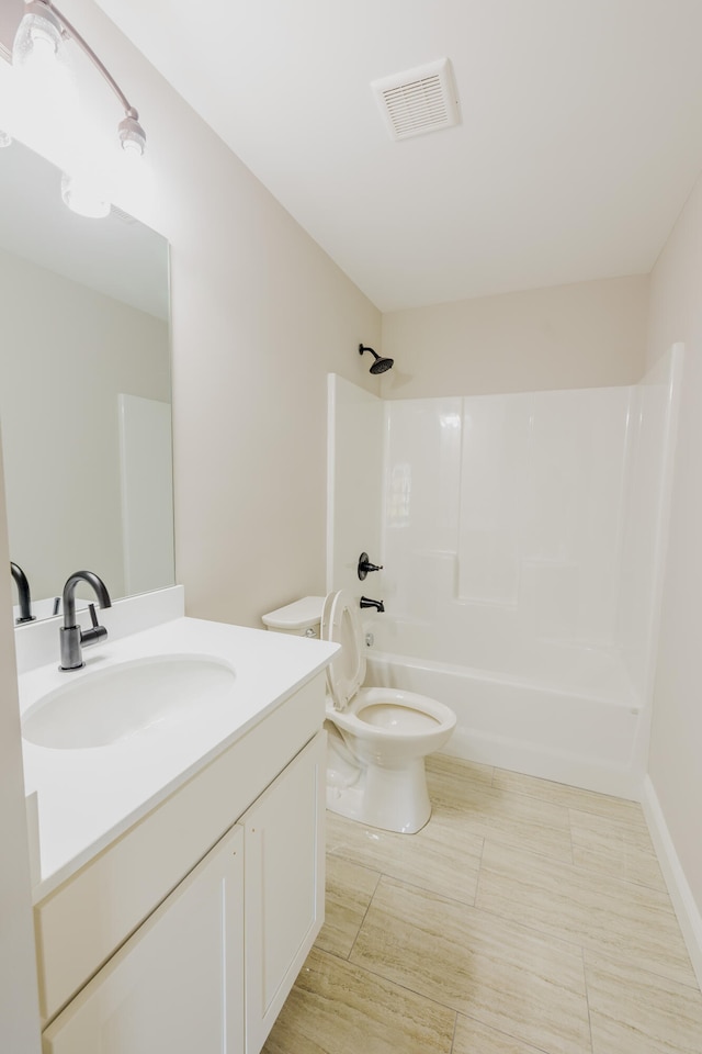 full bathroom with bathtub / shower combination, vanity, and toilet