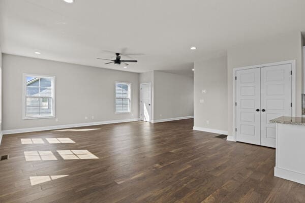 unfurnished living room with recessed lighting, dark wood-style flooring, baseboards, visible vents, and a ceiling fan