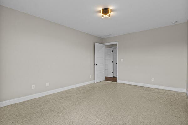 empty room with carpet flooring and baseboards