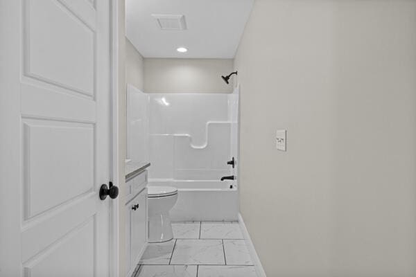 full bathroom featuring vanity, toilet, marble finish floor, bathtub / shower combination, and baseboards