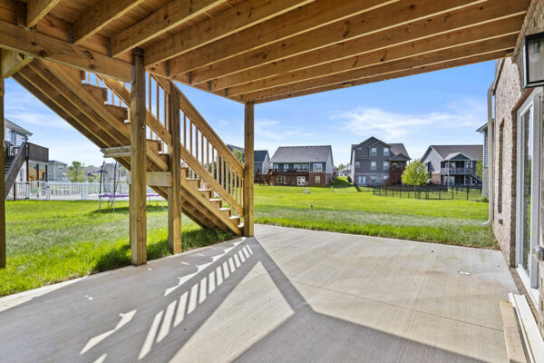 view of patio / terrace with fence, stairs, a residential view, and a trampoline