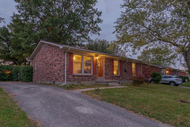 ranch-style house with a lawn