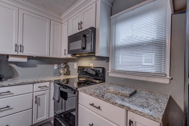 kitchen with light stone countertops, crown molding, black appliances, and white cabinets