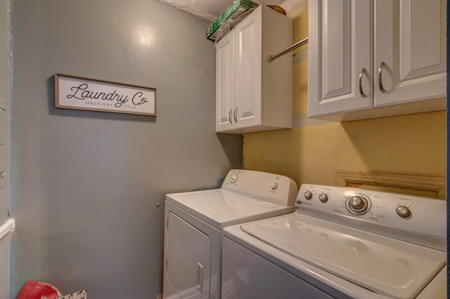 laundry room featuring cabinets and washer and clothes dryer