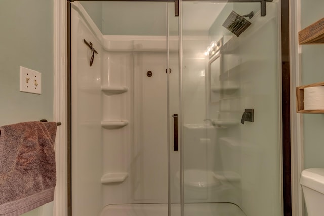 bathroom with toilet and walk in shower