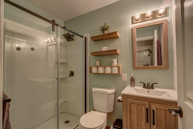 bathroom featuring vanity, toilet, and a shower with door