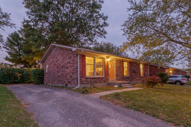 ranch-style home with a lawn and a porch