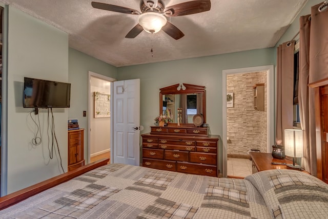 bedroom featuring ceiling fan, a textured ceiling, and ensuite bath