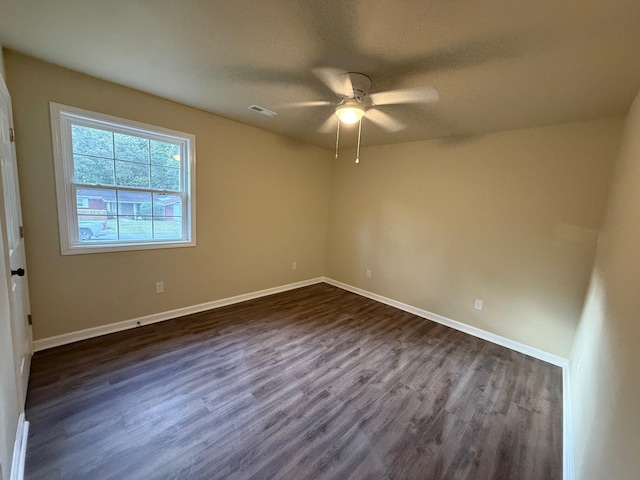 unfurnished room with ceiling fan and dark wood-type flooring