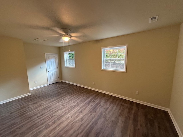 unfurnished room featuring ceiling fan and dark wood-type flooring